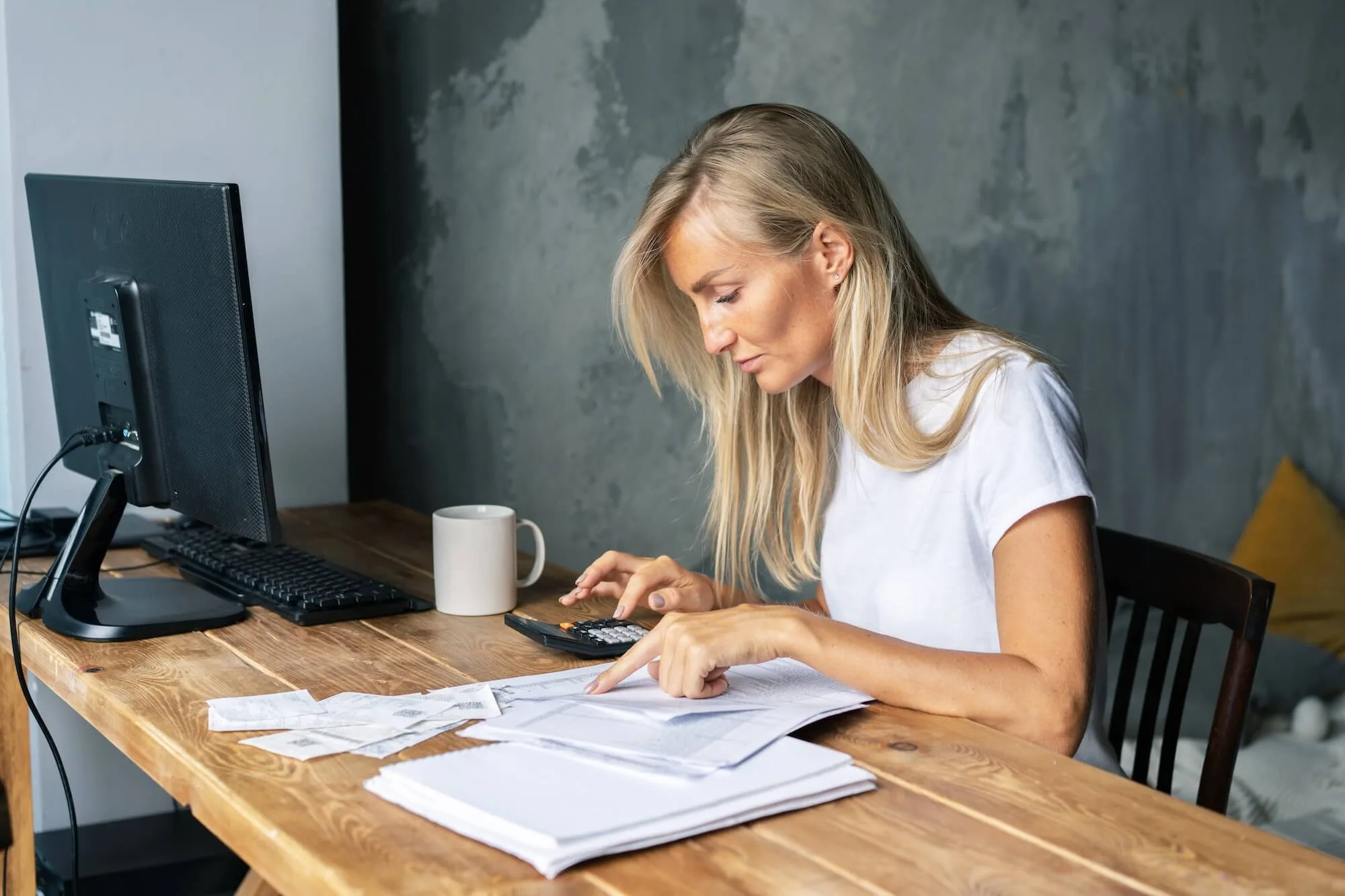 business-woman-at-her-desk-does-the-bookkeeping-settles-bills-and-controls-the-business.jpg